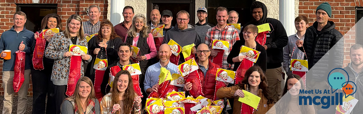 McGill Hickory Office stands outside McGill Hickory building to show off Angel Tree Stockings for 2026 Volunteering
