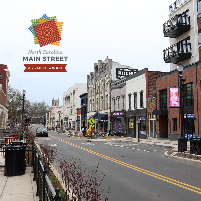 Concord Streetscape received NC Main Street award in 2026. Picture shows main street looking towards arts center with main street award logo.