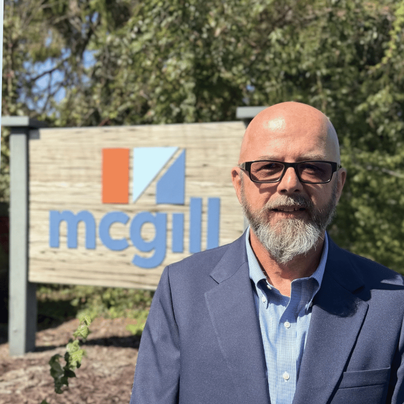 Picture of Mark Ingle, IT Director, in front of McGill sign