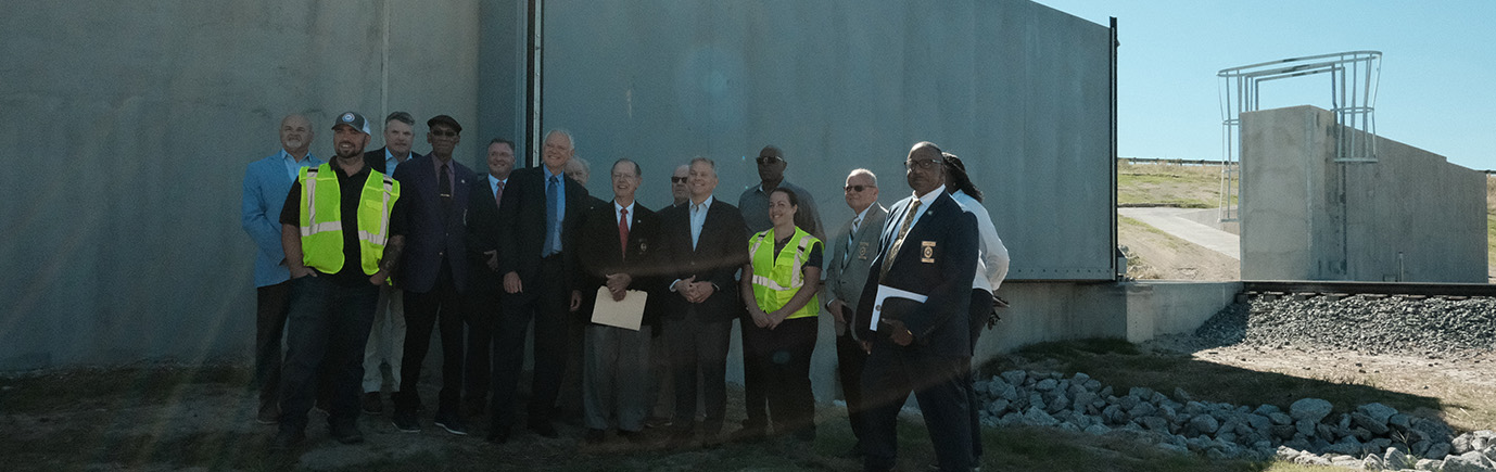 Group of stakeholders in front of new West Lumberton Floodgate for ribbon cutting